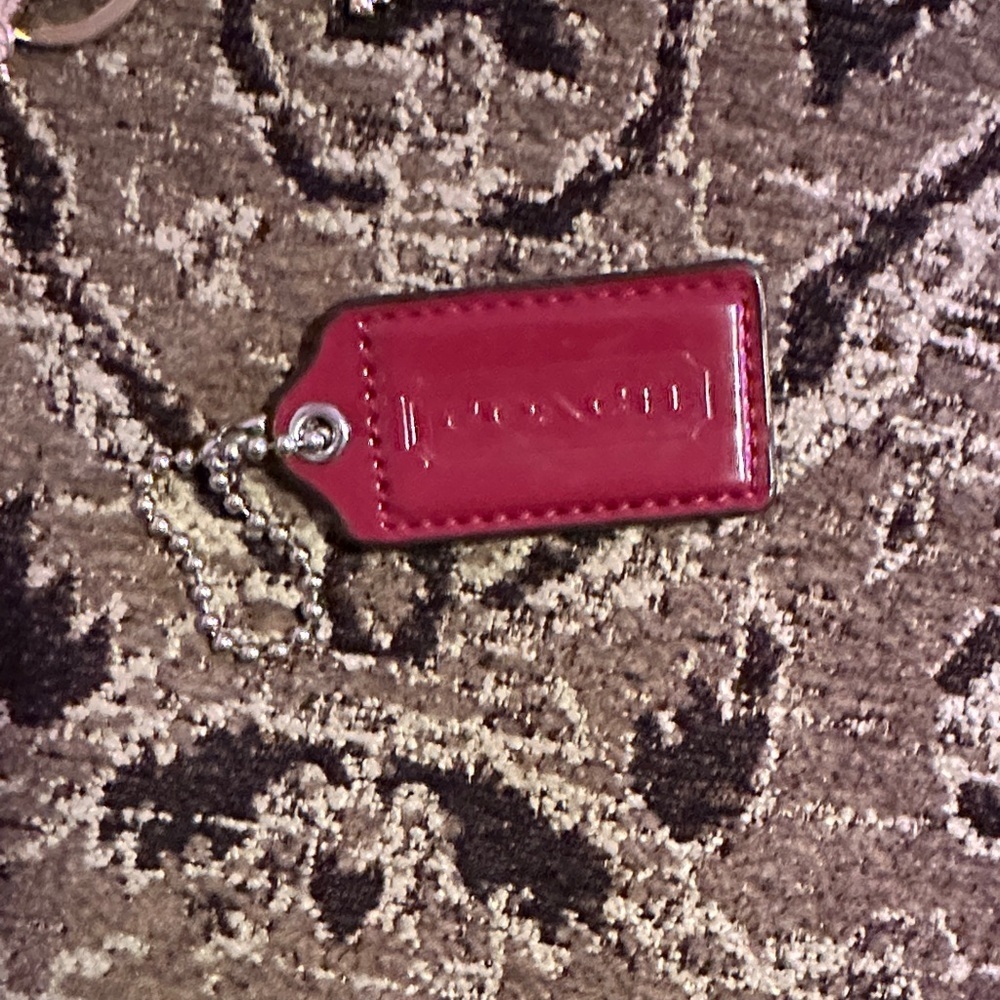 Coach Burgundy Keychain w/ silver hardware
2.5 inches.